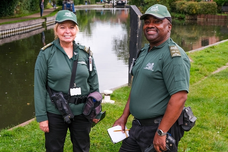 A photograph of two Civil Enforcement Officers stood by the river in Newbury