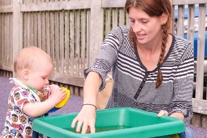 A woman playing with a toddler at one of our Family Hub Stay and Play sessions.