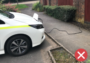 A power cable trailing across a footway is a potential trip hazard for disabled and vulnerable people