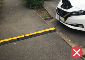 A power cable trailing across a footway is a potential trip hazard for disabled and vulnerable people